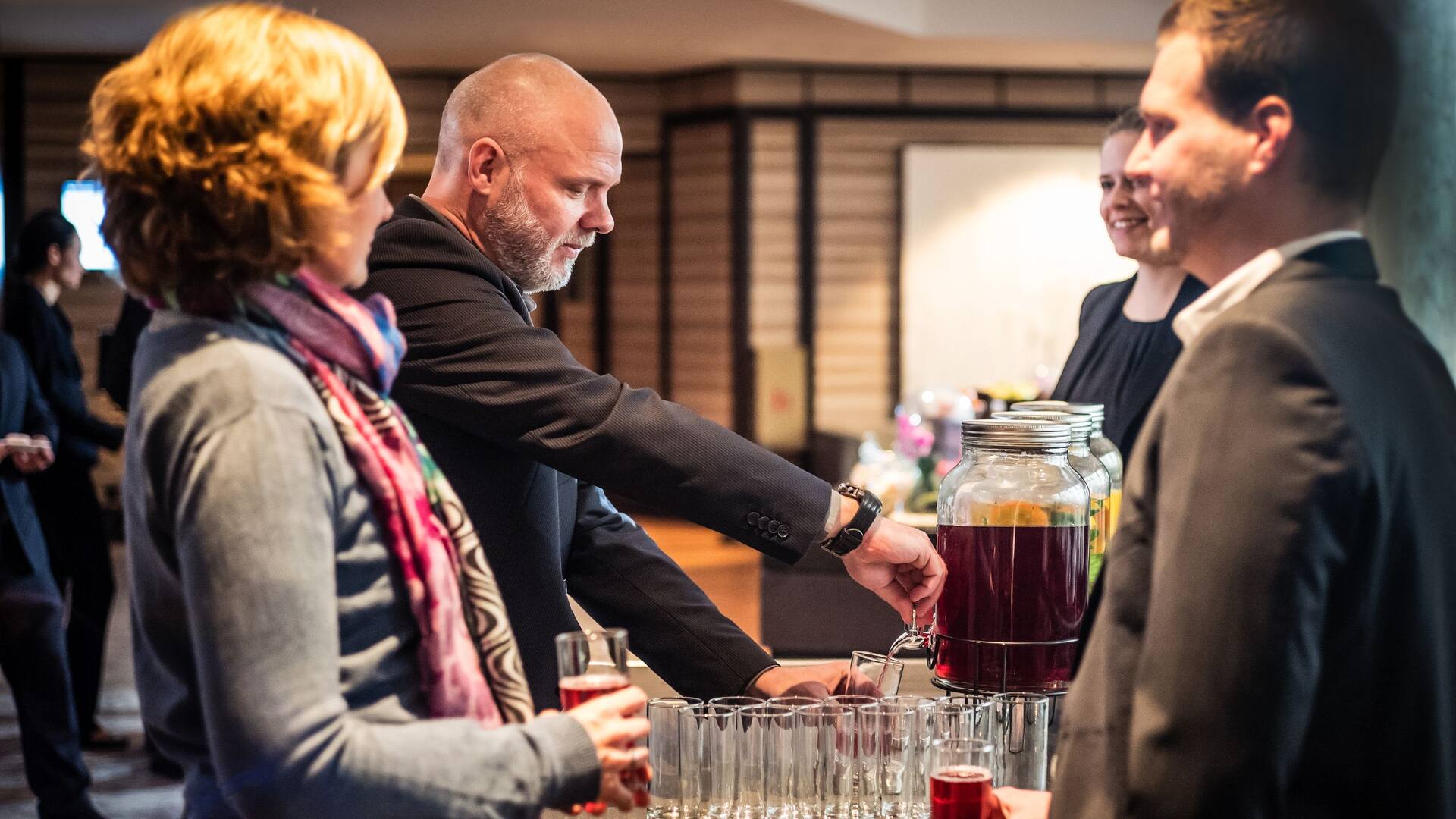 Meeting Teilnehmer bedienen sich an Getränkestation im Hyatt Regency Köln