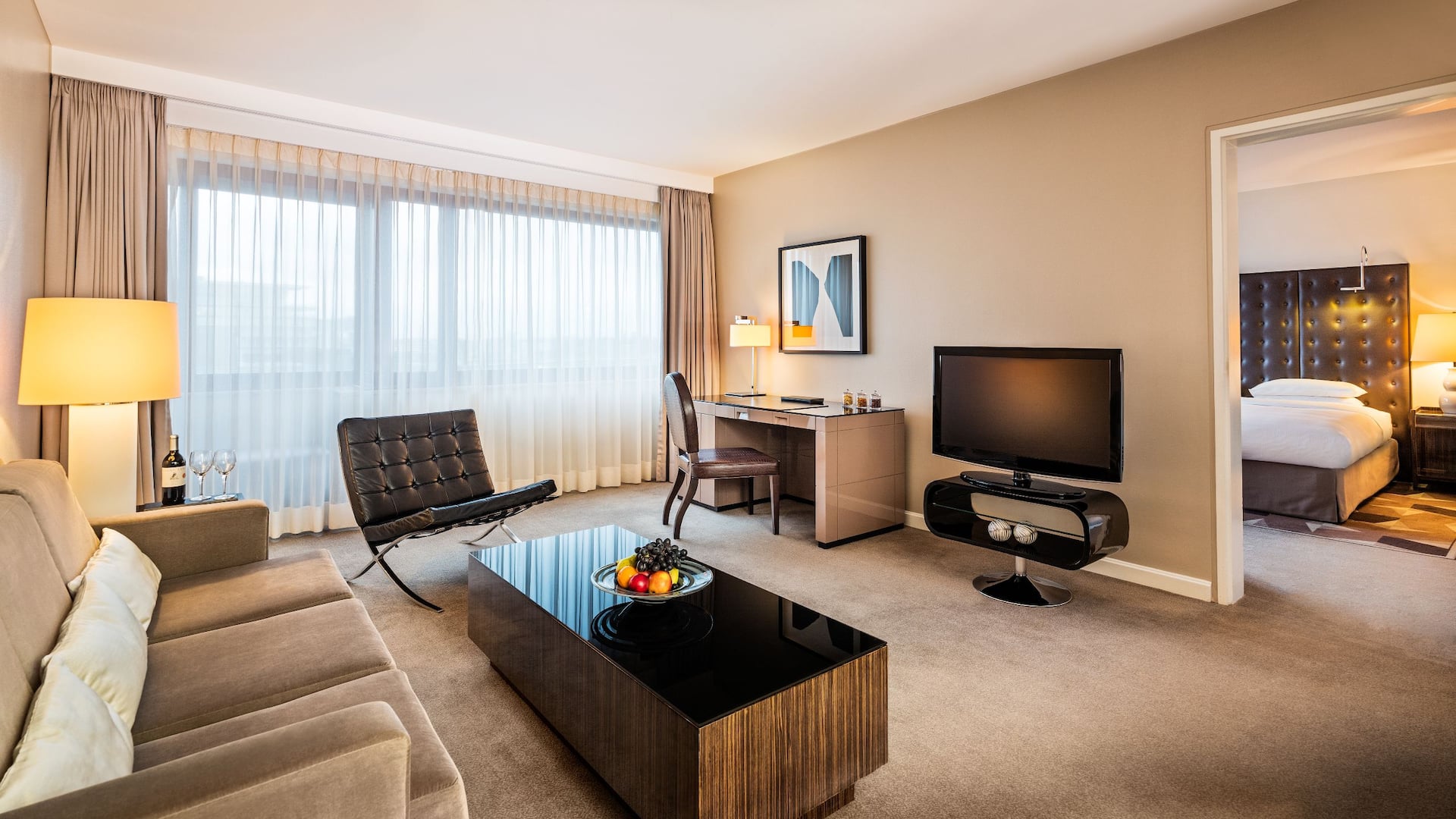 Living area with sofa and TV in Regency Suite at Hyatt Regency Cologne