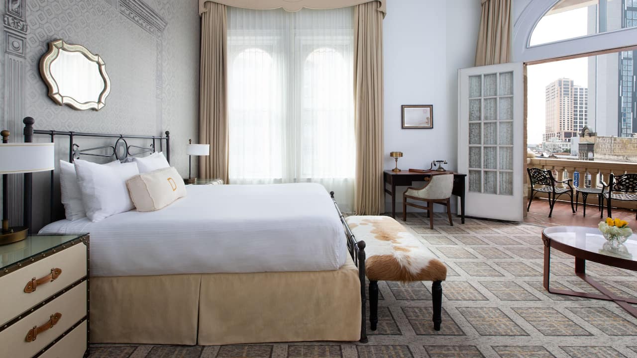 King Bed guestroom with french doors opening to a large balcony