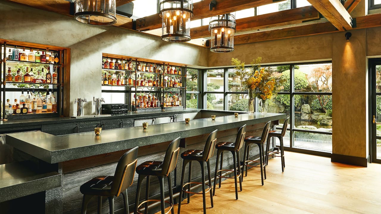 Hotel bar countertop seating with loft-style windows