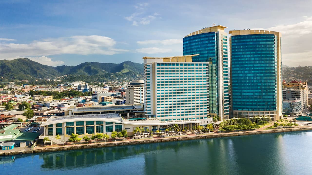 Aerial view of Hyatt Regency Trinidad and surrounding buildings with mountains in the background