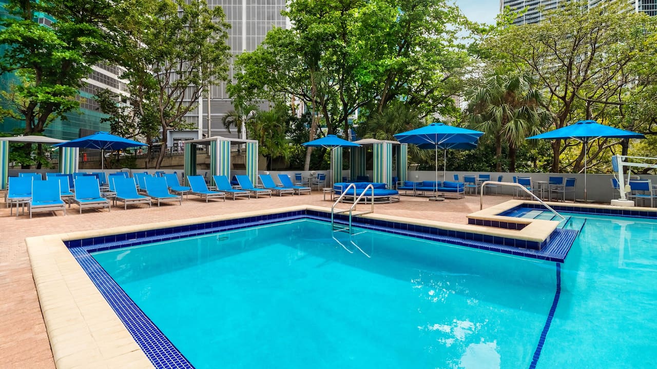 Outdoor Pool with sun umbrellas and lounge chairs