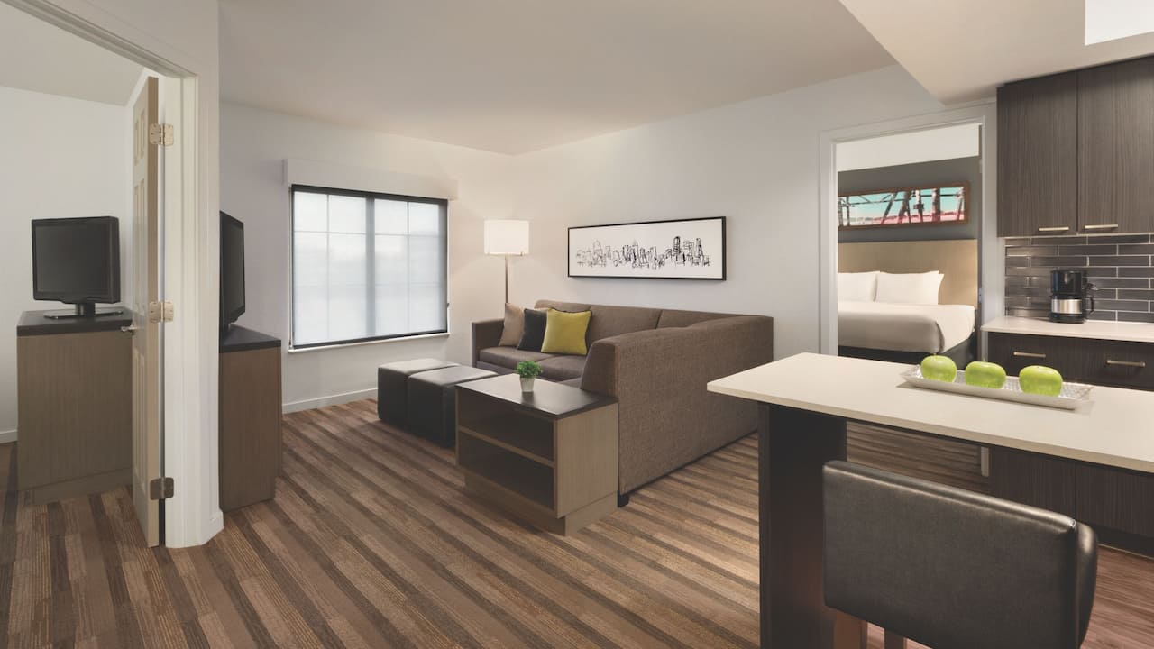 Two-bedroom suite with king beds, living room with sofa and in room kitchen at Hyatt House Boston / Burlington