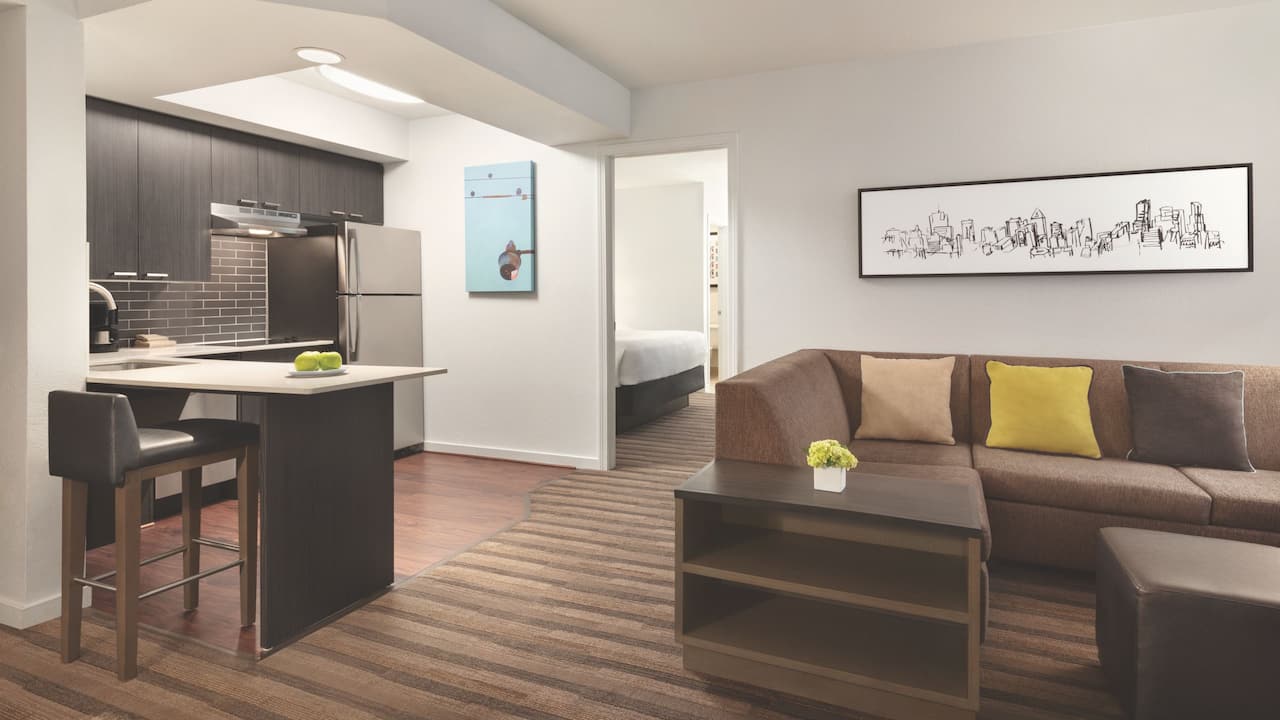 Accessible two bedroom king and queen suite living room space and kitchenette area at Hyatt House Boston / Burlington