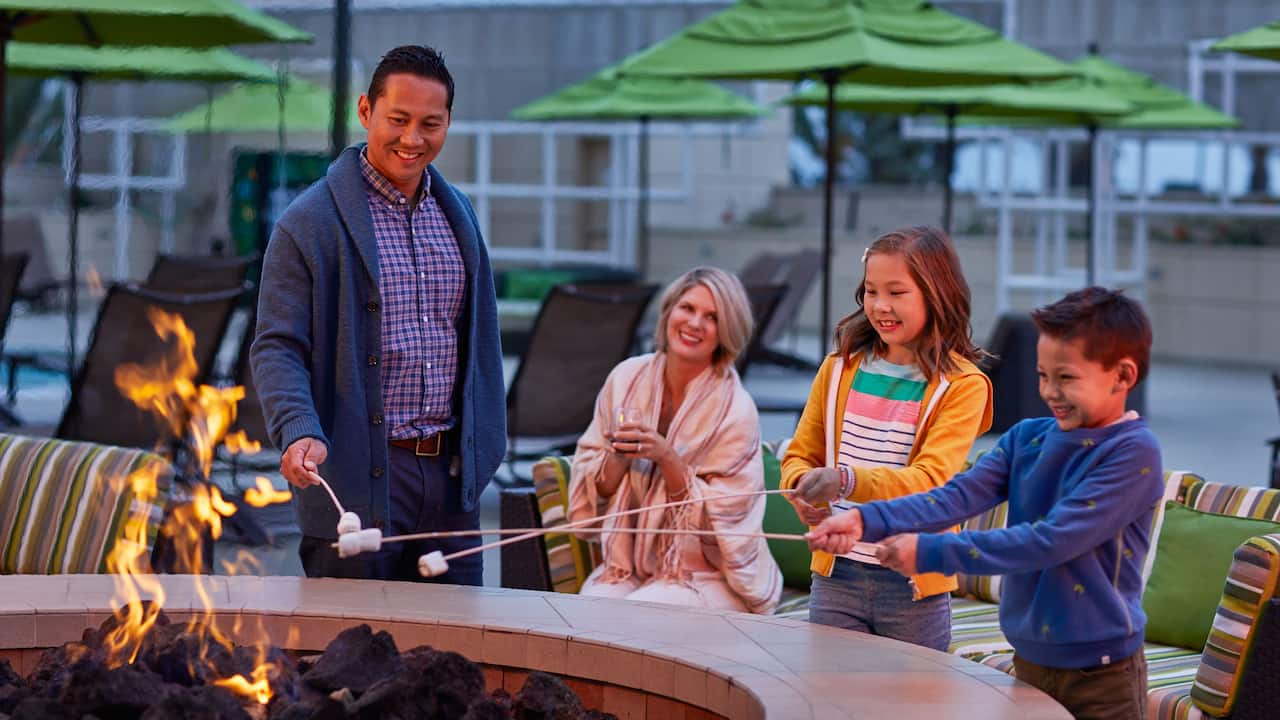 Firepit with family roasting marshmallows