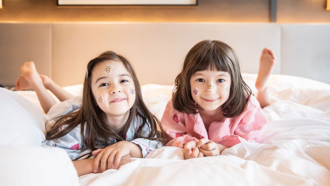 Children playing in hotel bed