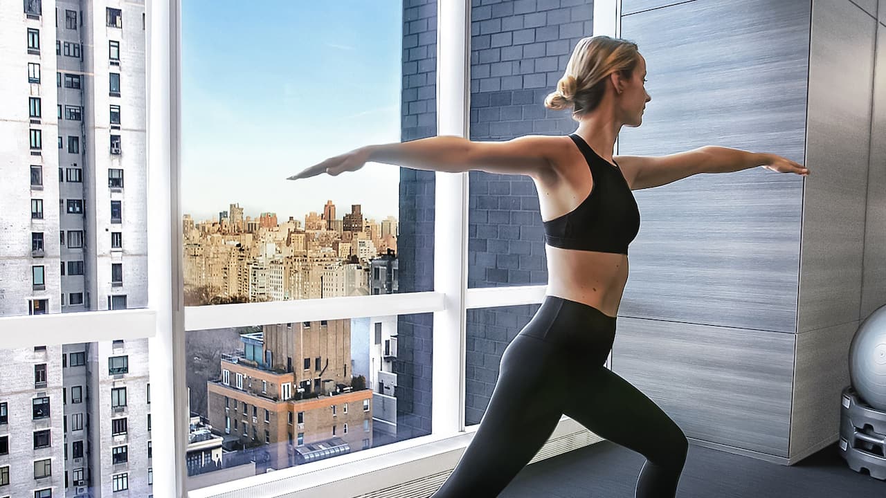 Fitness Center with guest practicing yoga