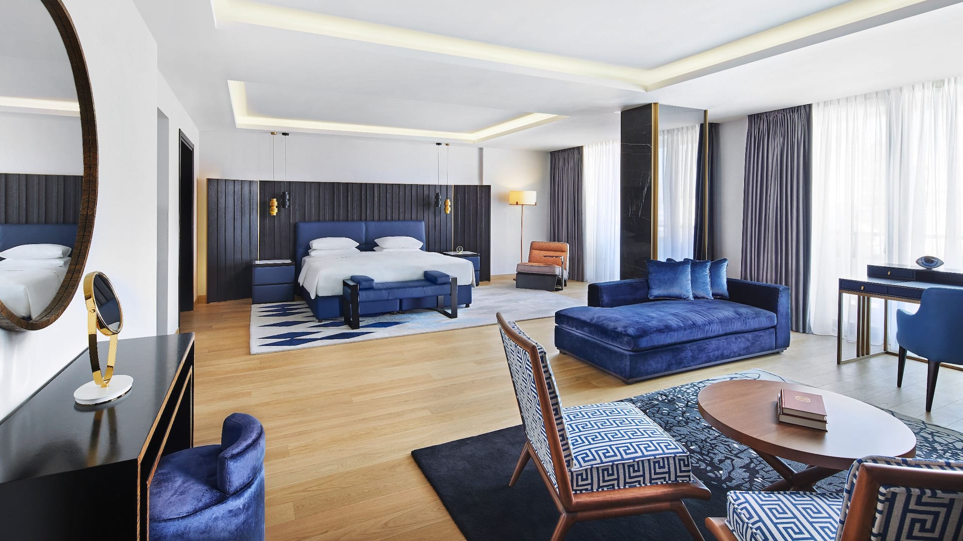 Interior of Athens Acropolis 5-star hotel suite with a royal blue color scheme and eclectic decor for an iconic stay.