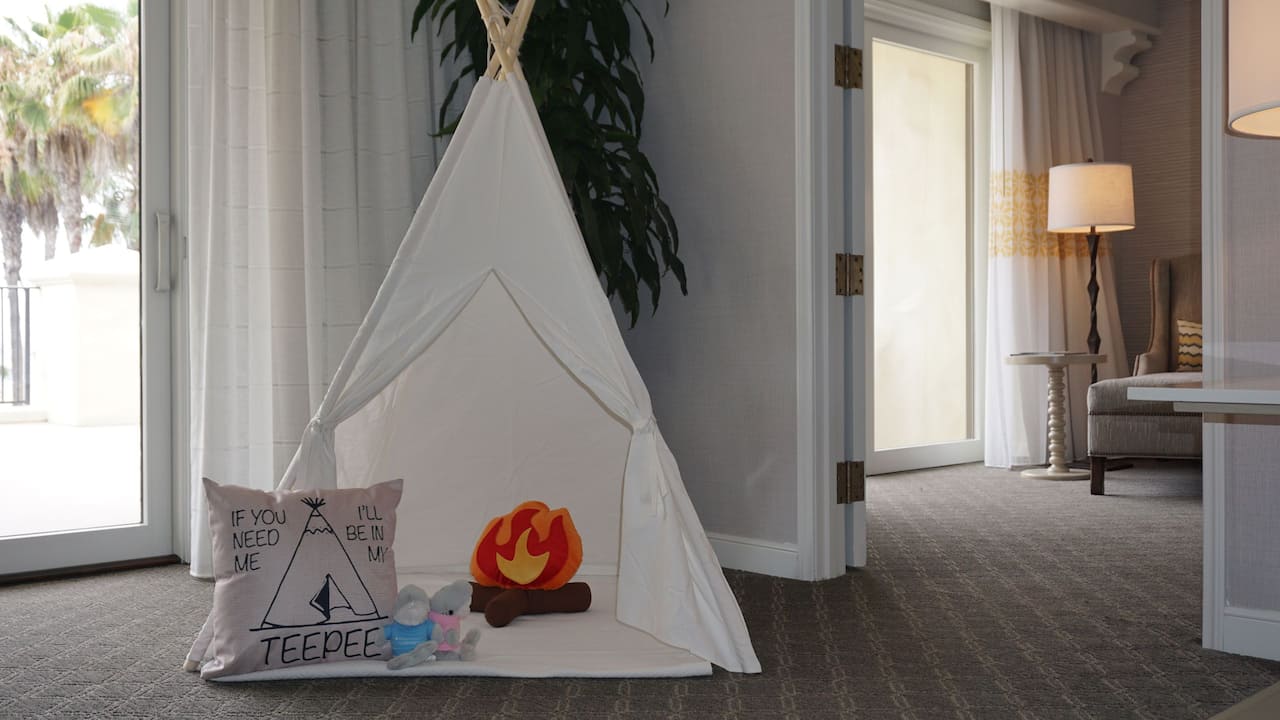 Child’s teepee setup in a suite with kids toys in teepee