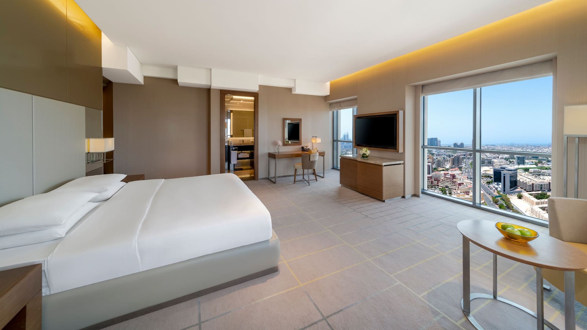 A room with a king bed facing view of Dubai at Hyatt Regency Dubai Creek Heights.