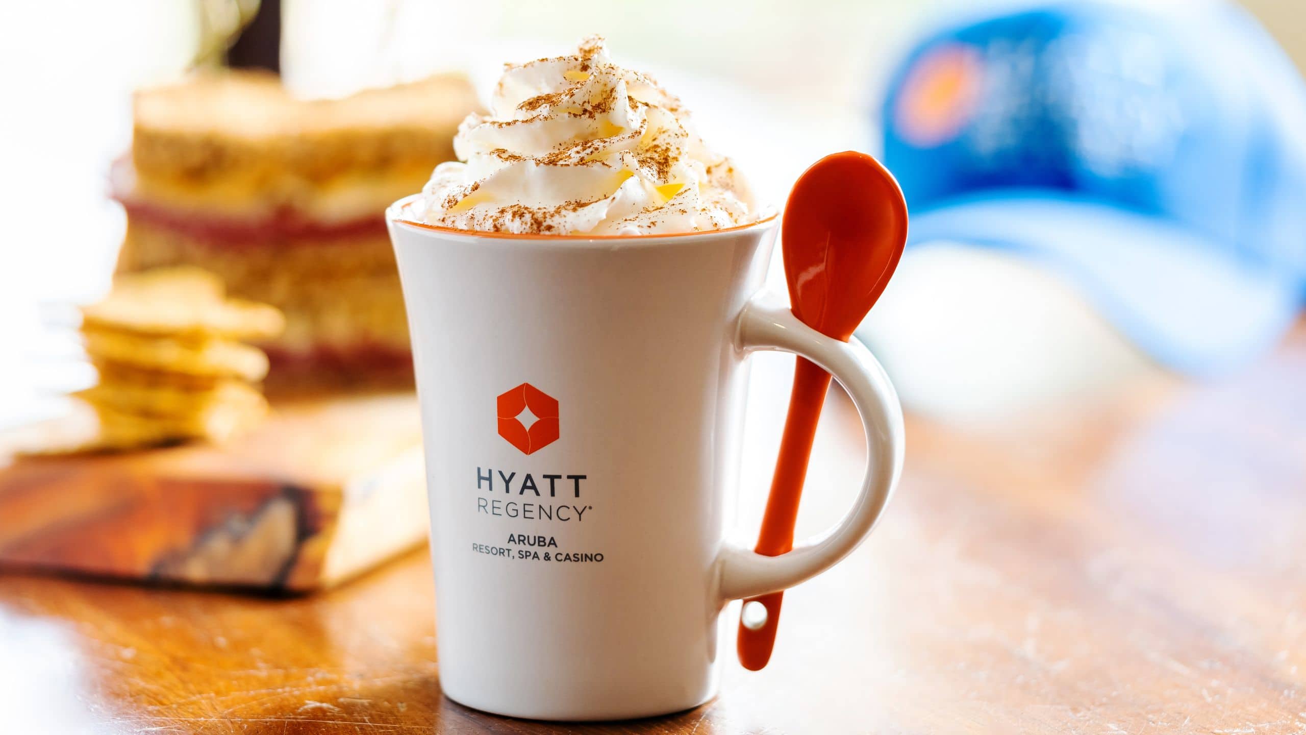 Coffee with whipped cream and cinnamon in a Hyatt coffee cup from Shoco Market Cafe