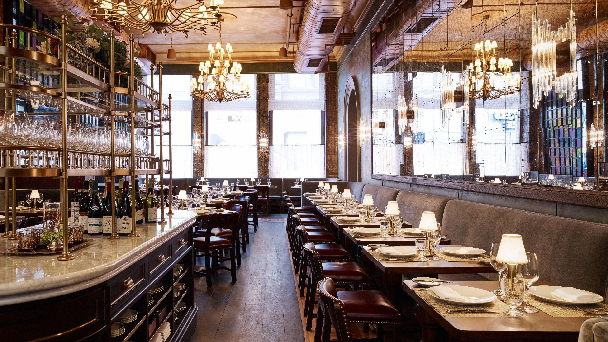 Temple Court restaurant with a long banquette and tables and chairs set for dinner