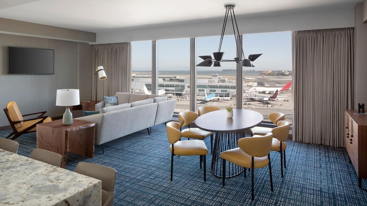 Executive Suite with dining table, living room seating area, and floor-to-ceiling window