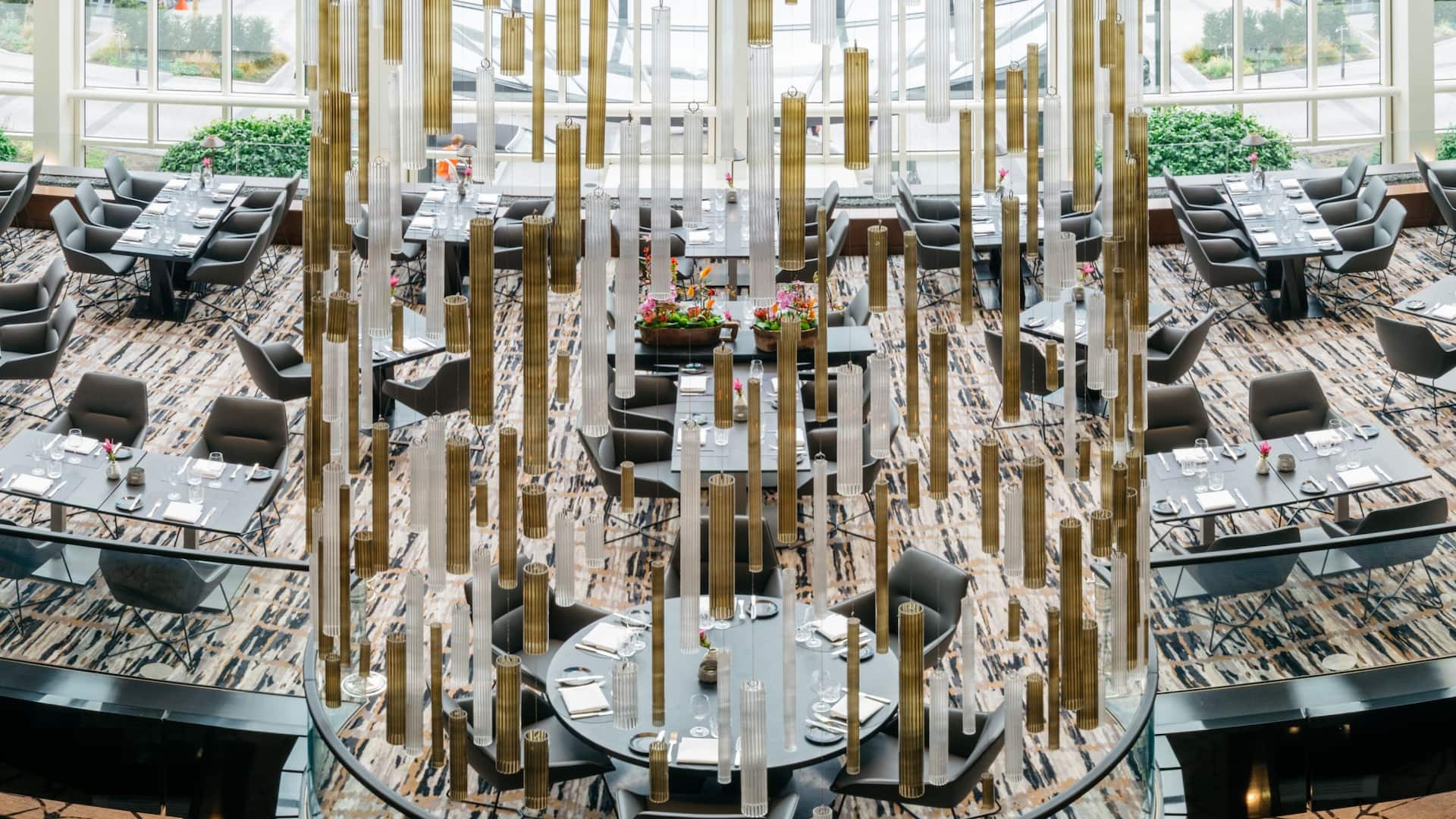 Panoramic image of Glashaus Restaurant at the Hyatt Regency Cologne with impressive glass construction in the middle
