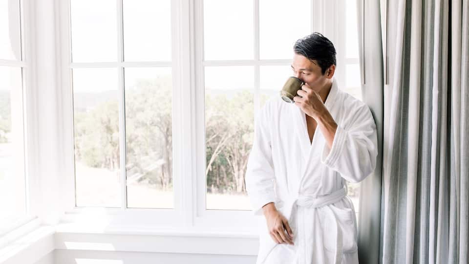Man Enjoying Cup of Coffee in Room