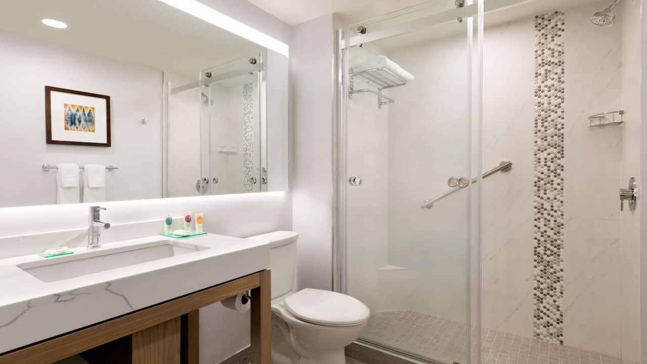 Guestroom bathroom with spacious vanity and walk-in shower 