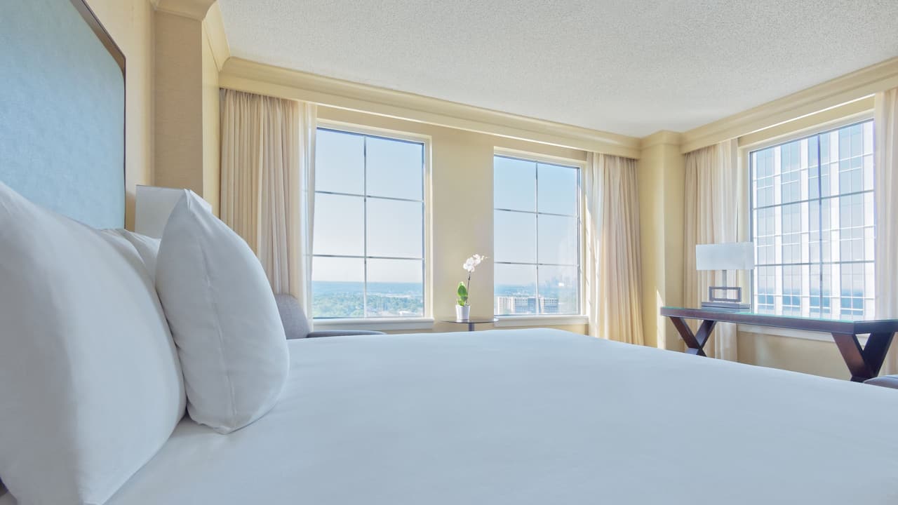 One King Bed Corner guest room with desk and armchair