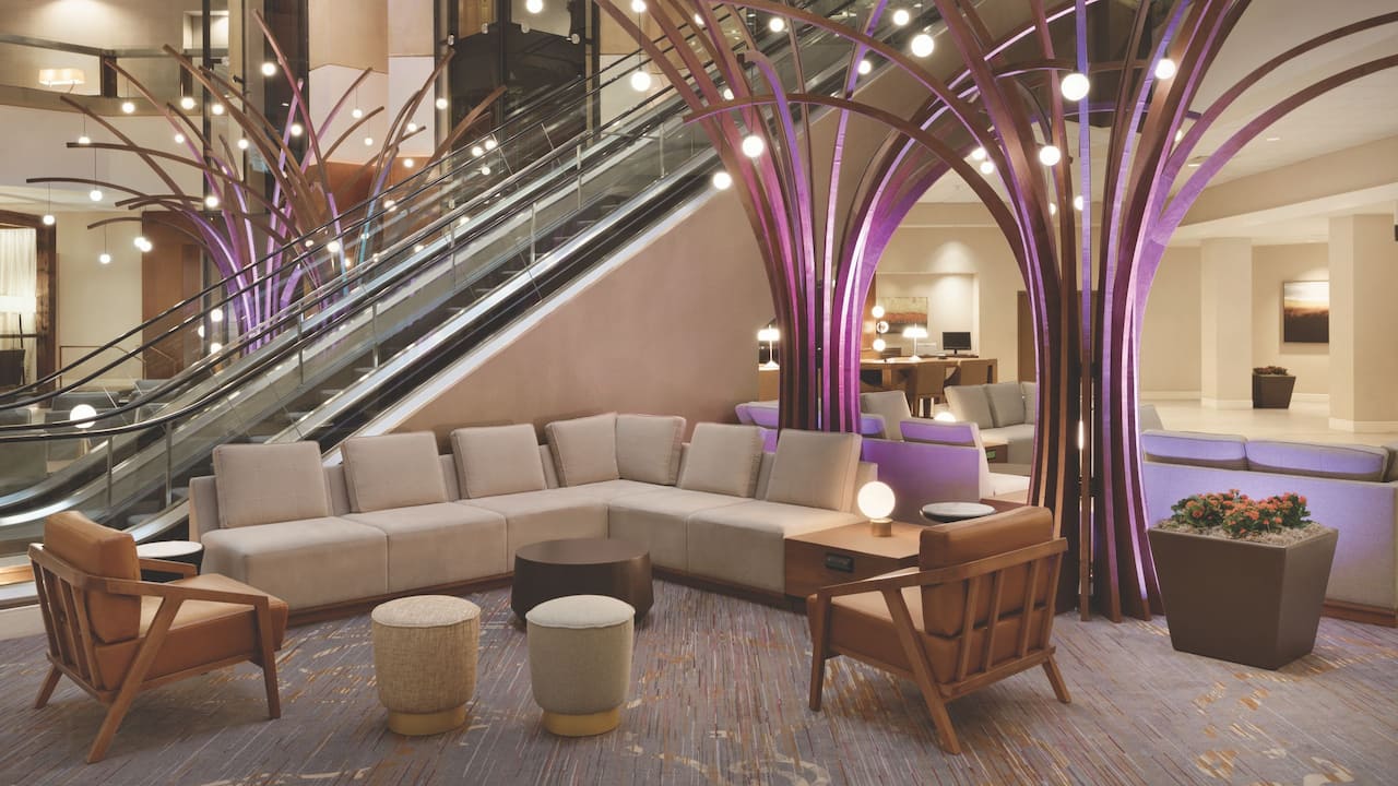 Lobby seating area with couch, lamps, and coffee table at Hyatt Regency Louisville