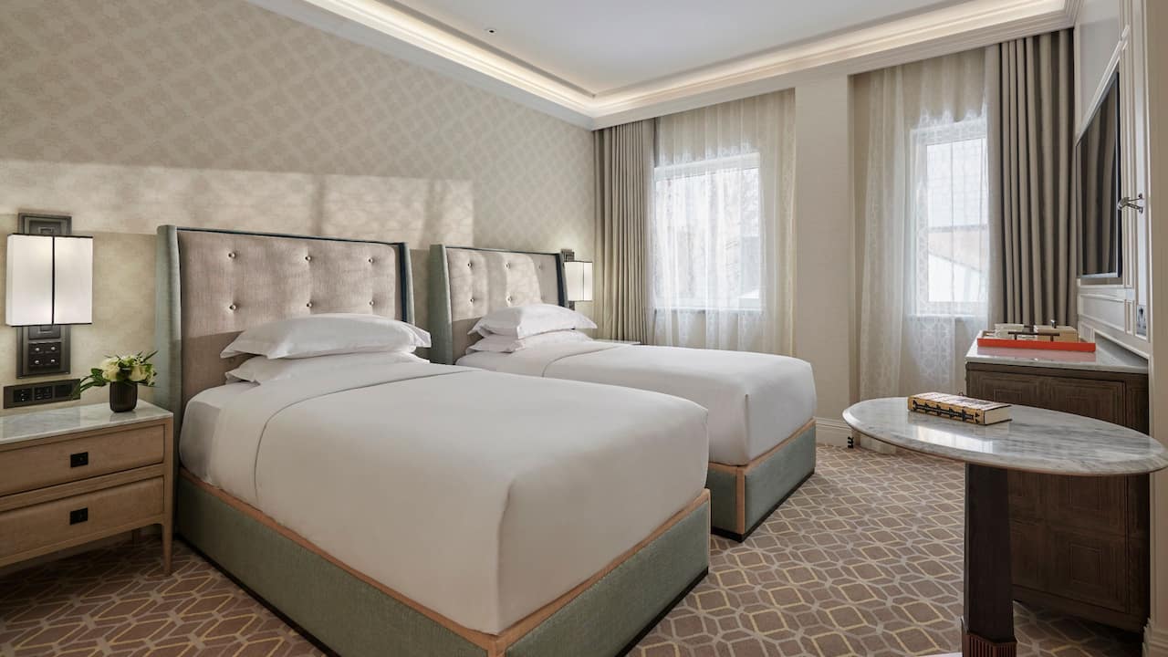 Hotel room with two twin beds and bedside tables