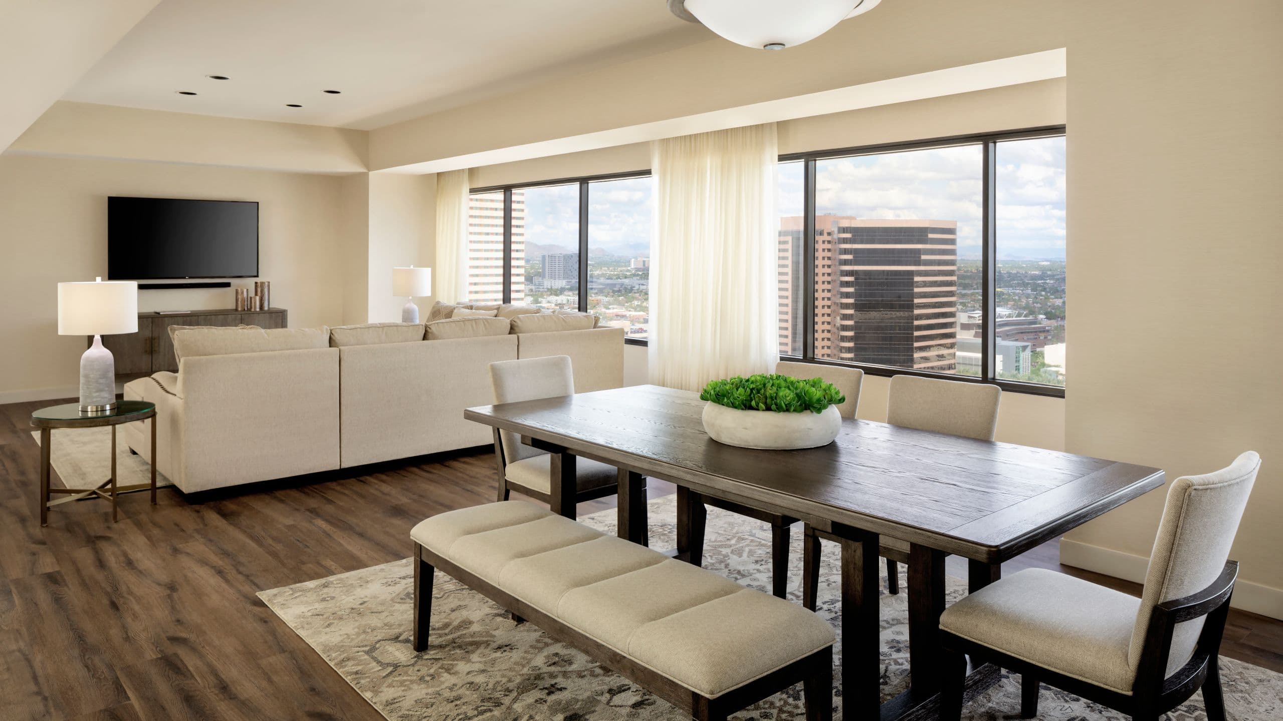A living room and dining area from a one bedroom hotel suite overlooking downtown Phoenix