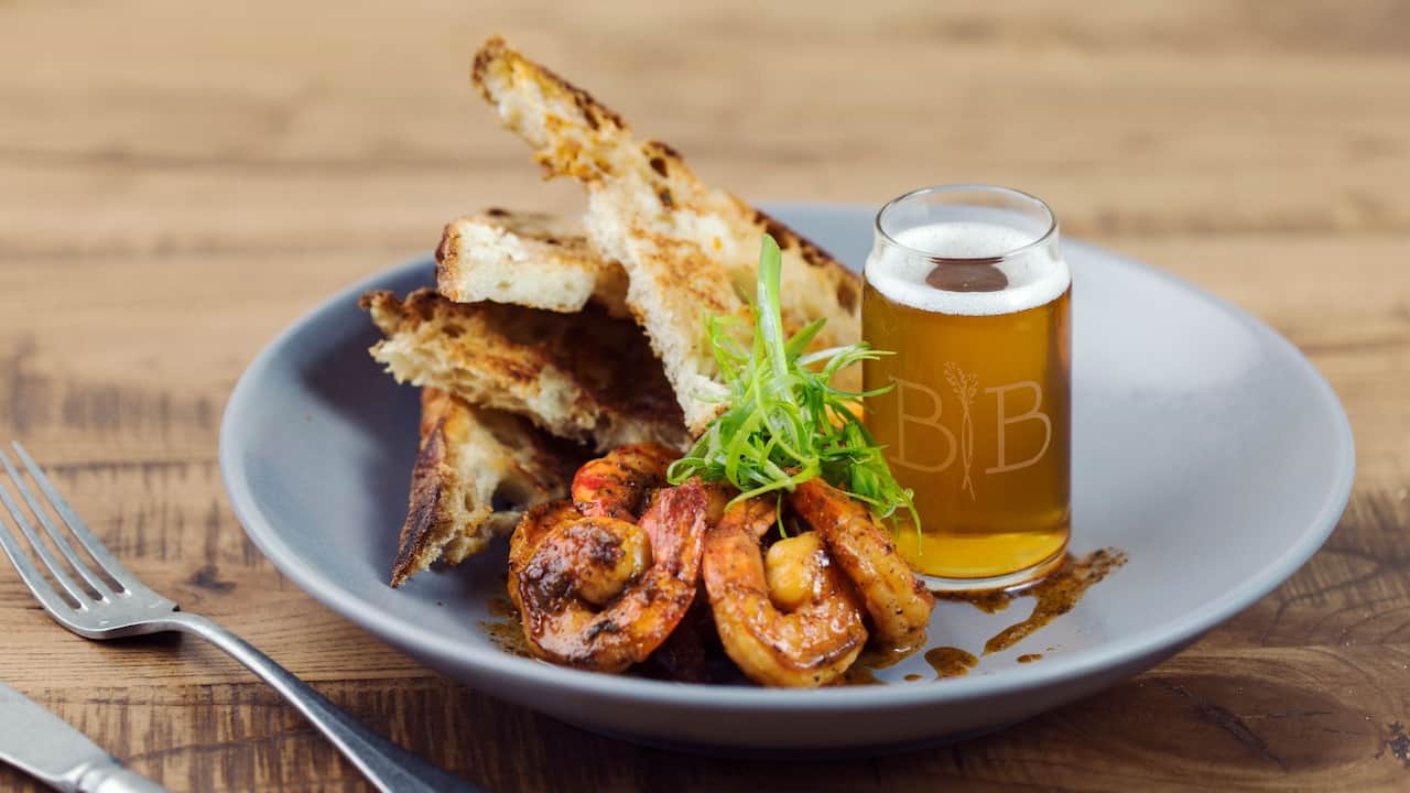 Barrel and Bushel menu item with shrimp, grilled sourdough, and a glass of beer