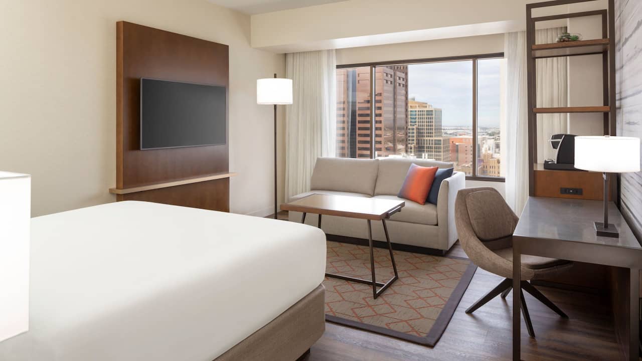 One king bed hotel room with a view of downtown Phoenix