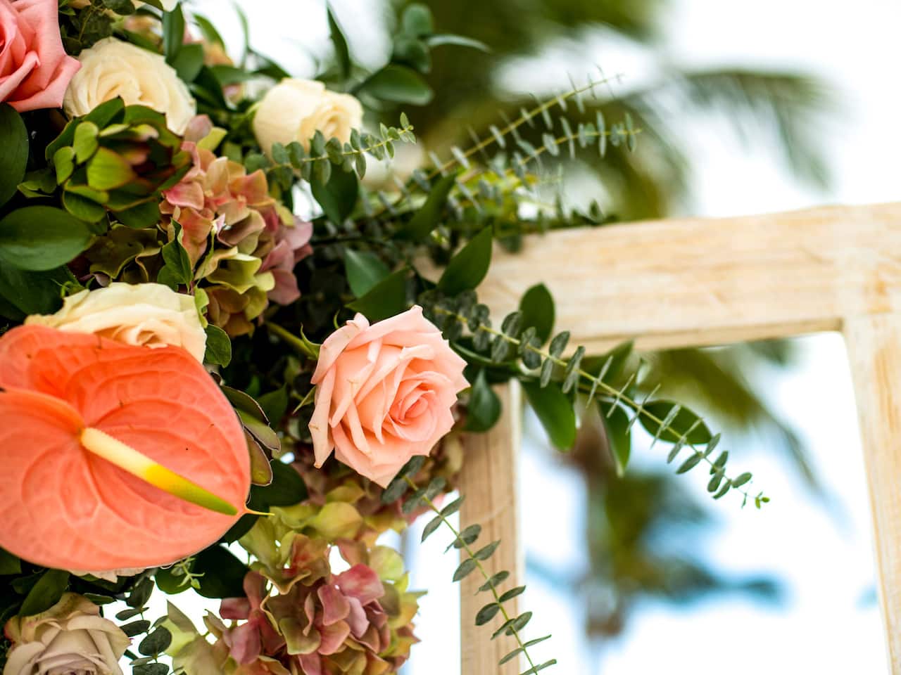 Wedding tables with place settings in hotel ballroom with view of resort