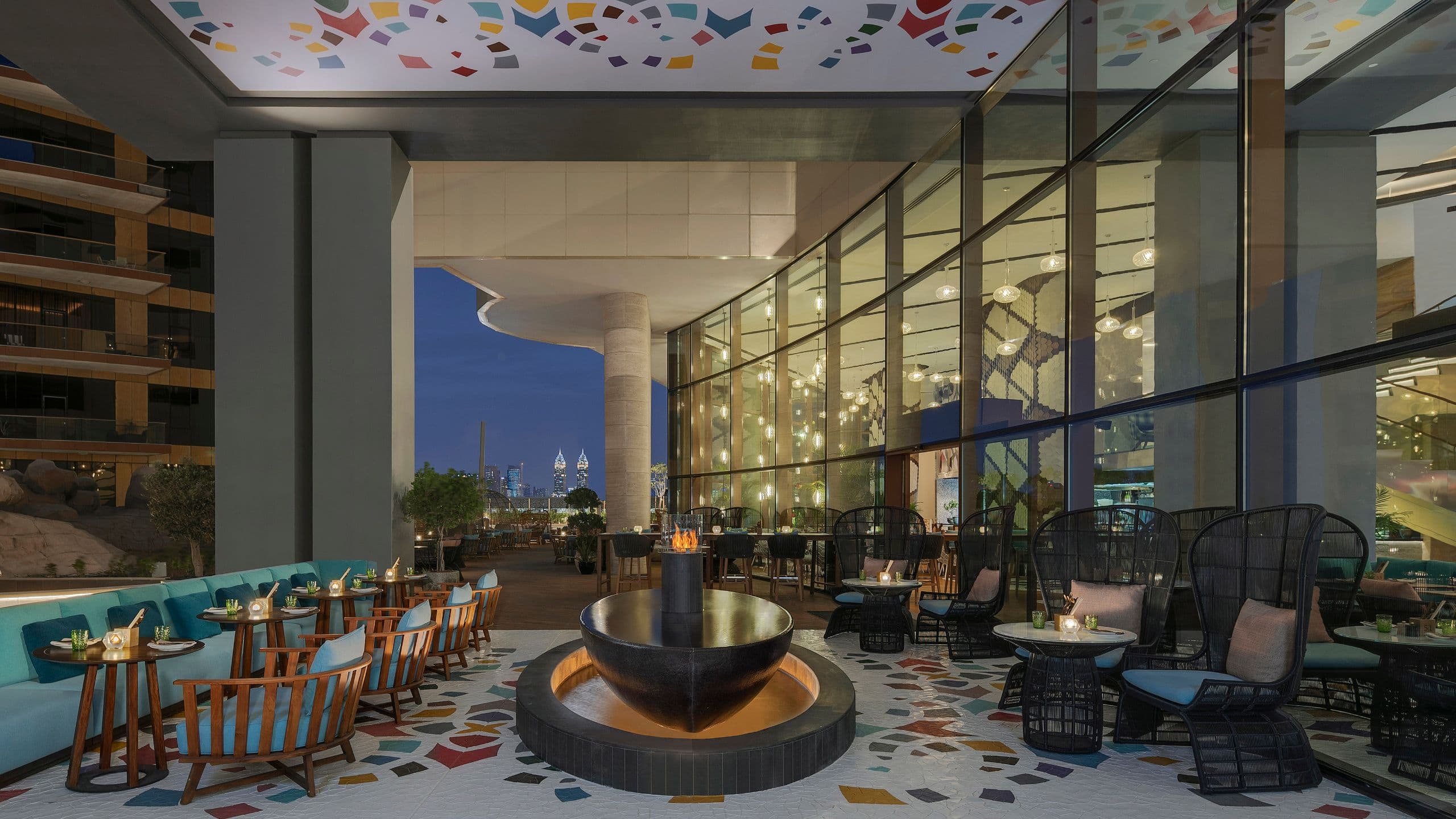 An outdoor seating area of The Locale, an all-day dining restaurant at Andaz Dubai The Palm.
