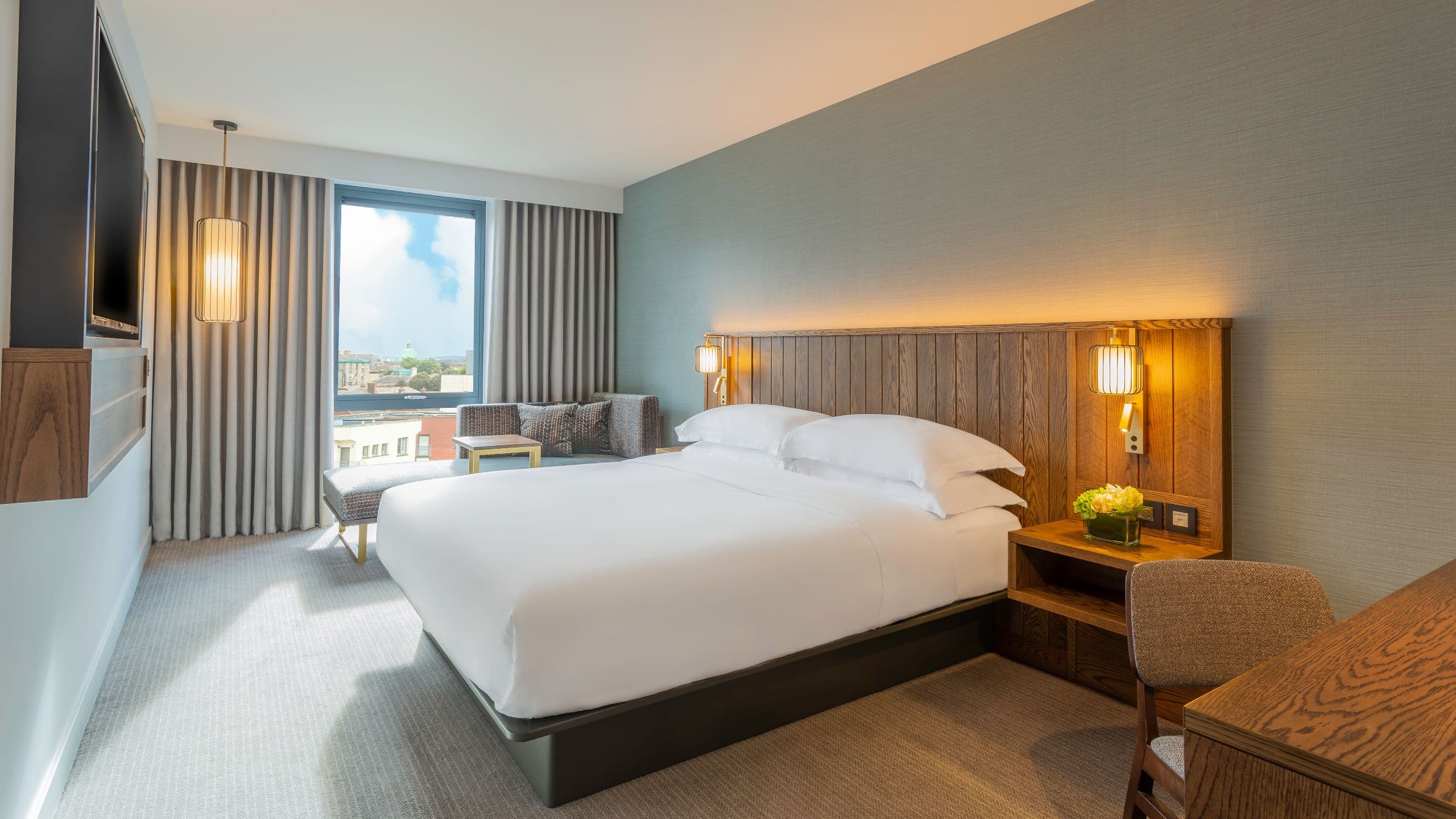 1 of 1 The interior view of our lavish King Bedroom boasting views out onto the street below and stylish floor to ceiling curtains and windows