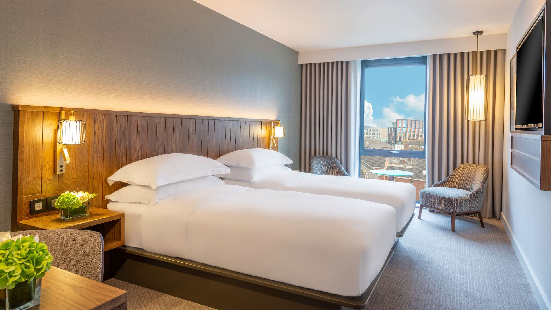 1 of 1 Our comfortable twin bedroom in Dublin city featuring a mixture of bright and earthy tones to help you relax.