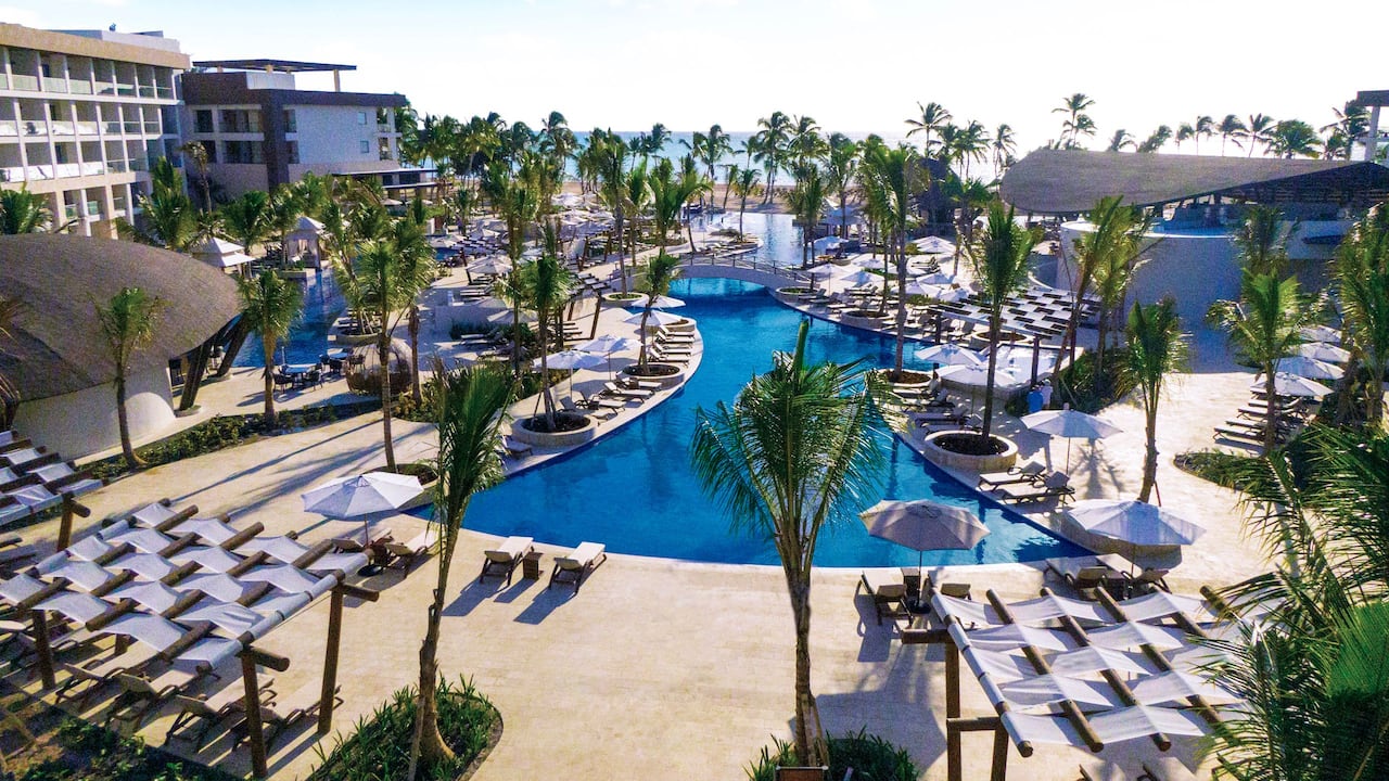 Aeriel view of white buildings, pools, and palm trees at Hyatt Ziva Cap Cana 