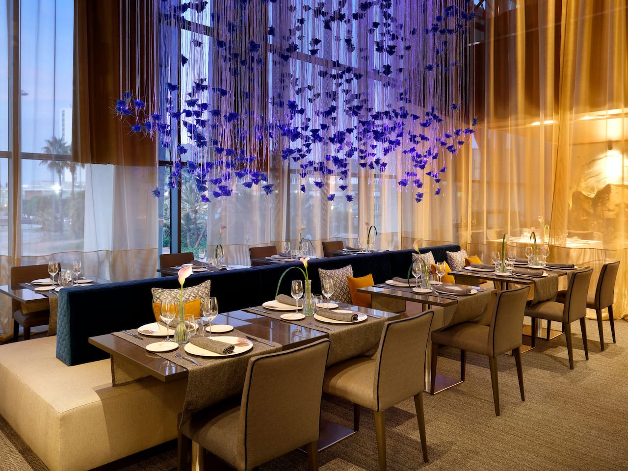 Tables arranged in a unique setting in the Terrum restaurant located on the second floor of our Hyatt Regency Barcelona Tower hotel.