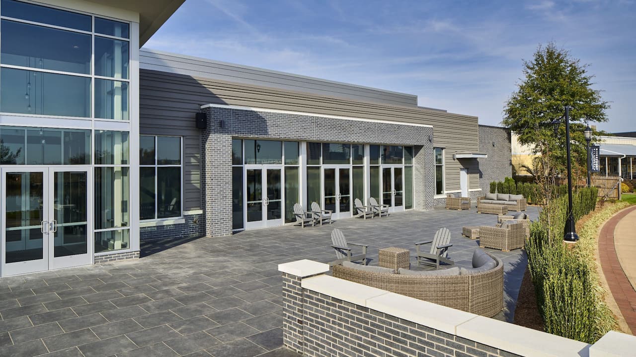 Riverfront terrace with Adirondack chairs and comfortable outdoor furniture