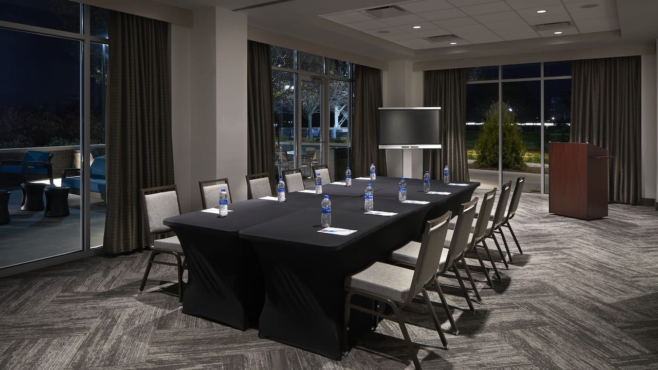 Hyatt Meeting Room with floor-to-ceiling windows, access to the terrace and arranged for a board meeting