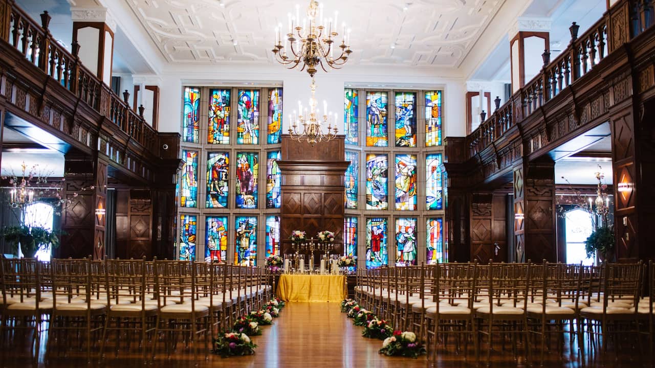 Tudor Ballroom set up for a wedding ceremony with elegant chandelier