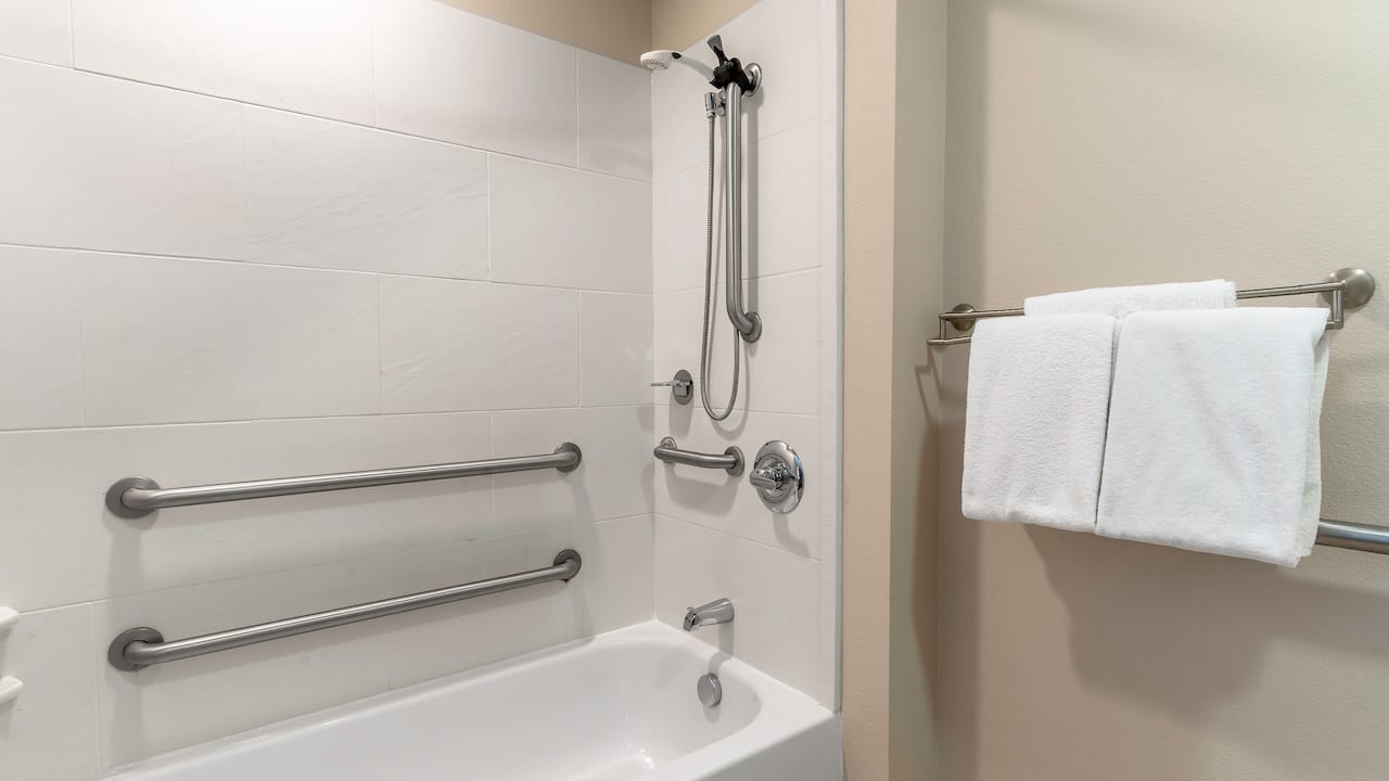 Accessible bathroom with bathtub equipped with grab rails at Hyatt House Richmond / Short Pump