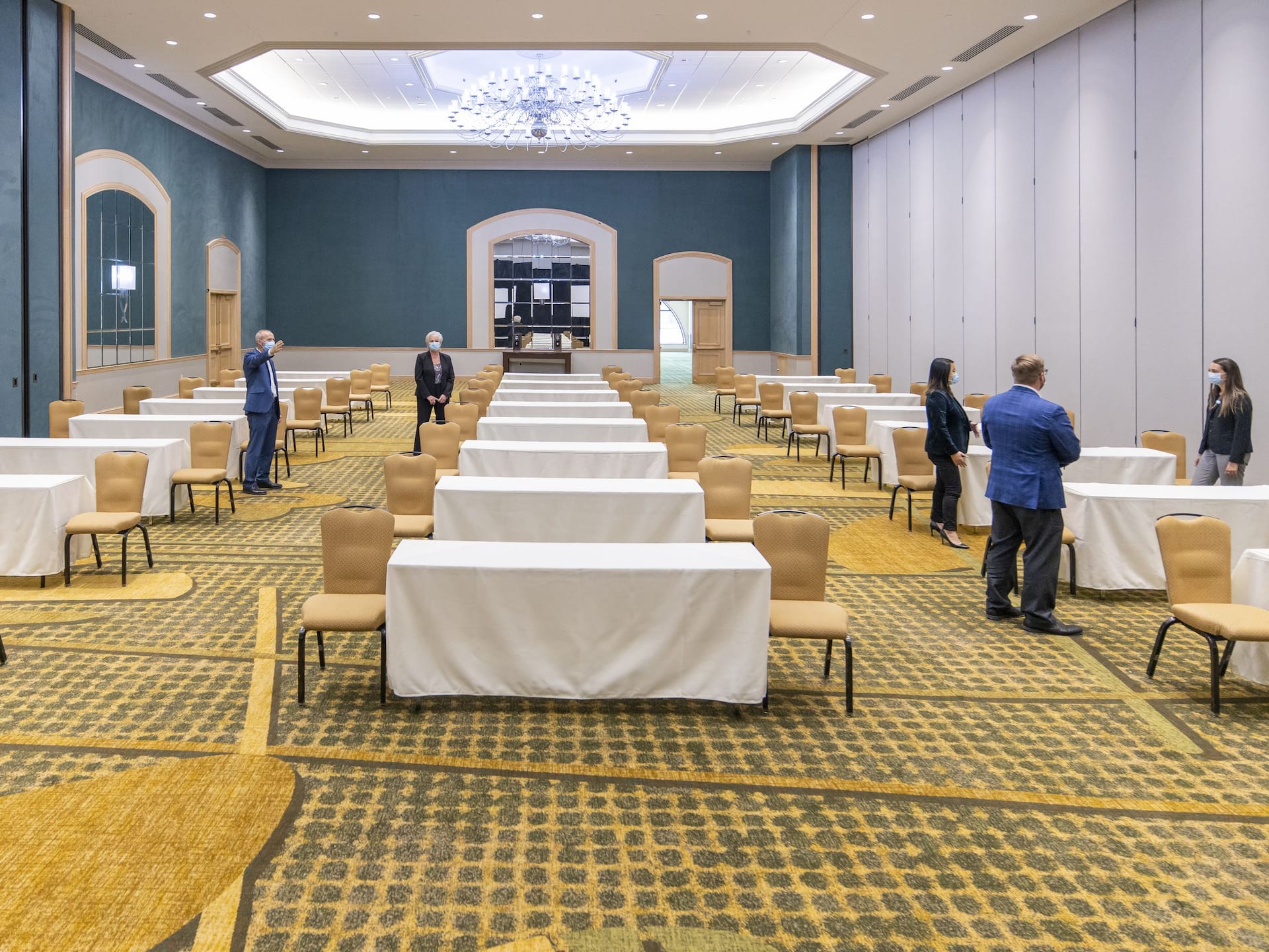 Global GLOBAL_P372 Colleagues with Face Masks Set Up and Tour Event Space