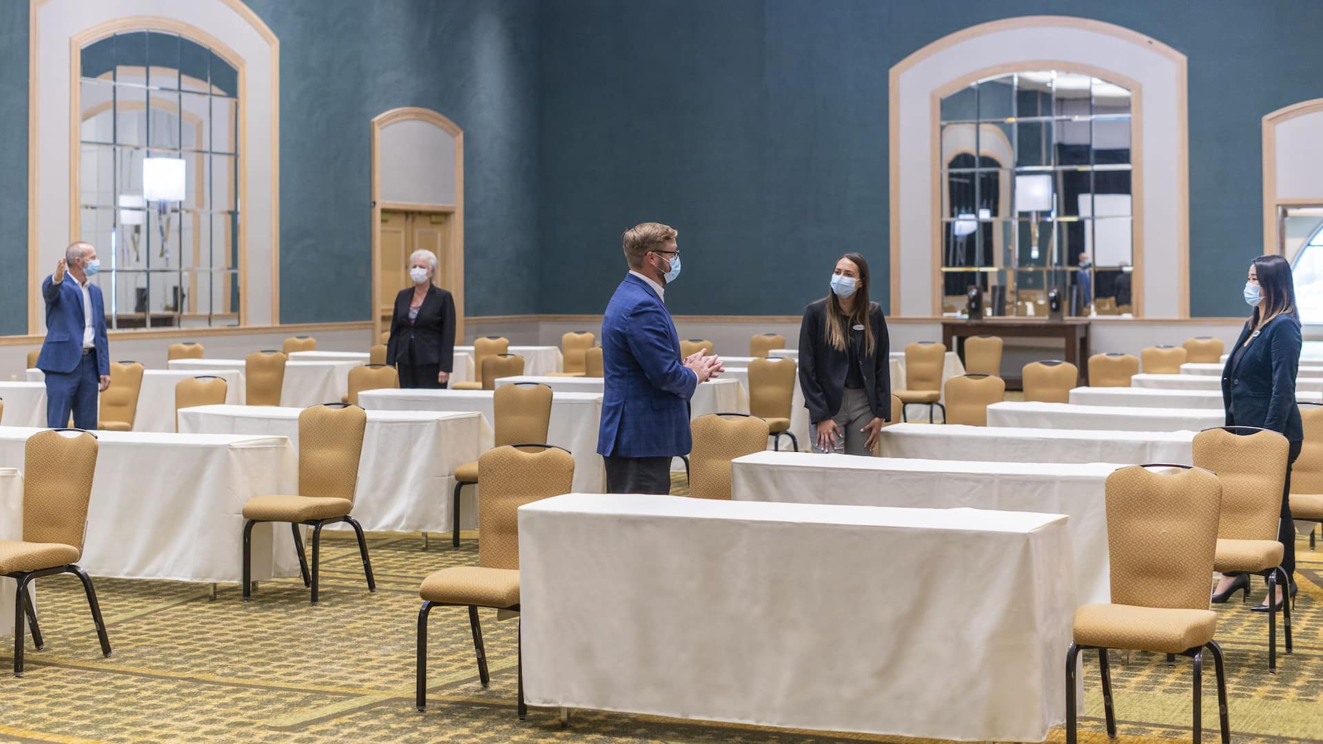 1 of 1 Global GLOBAL_P373 Colleagues with Face Masks Set Up Event Space