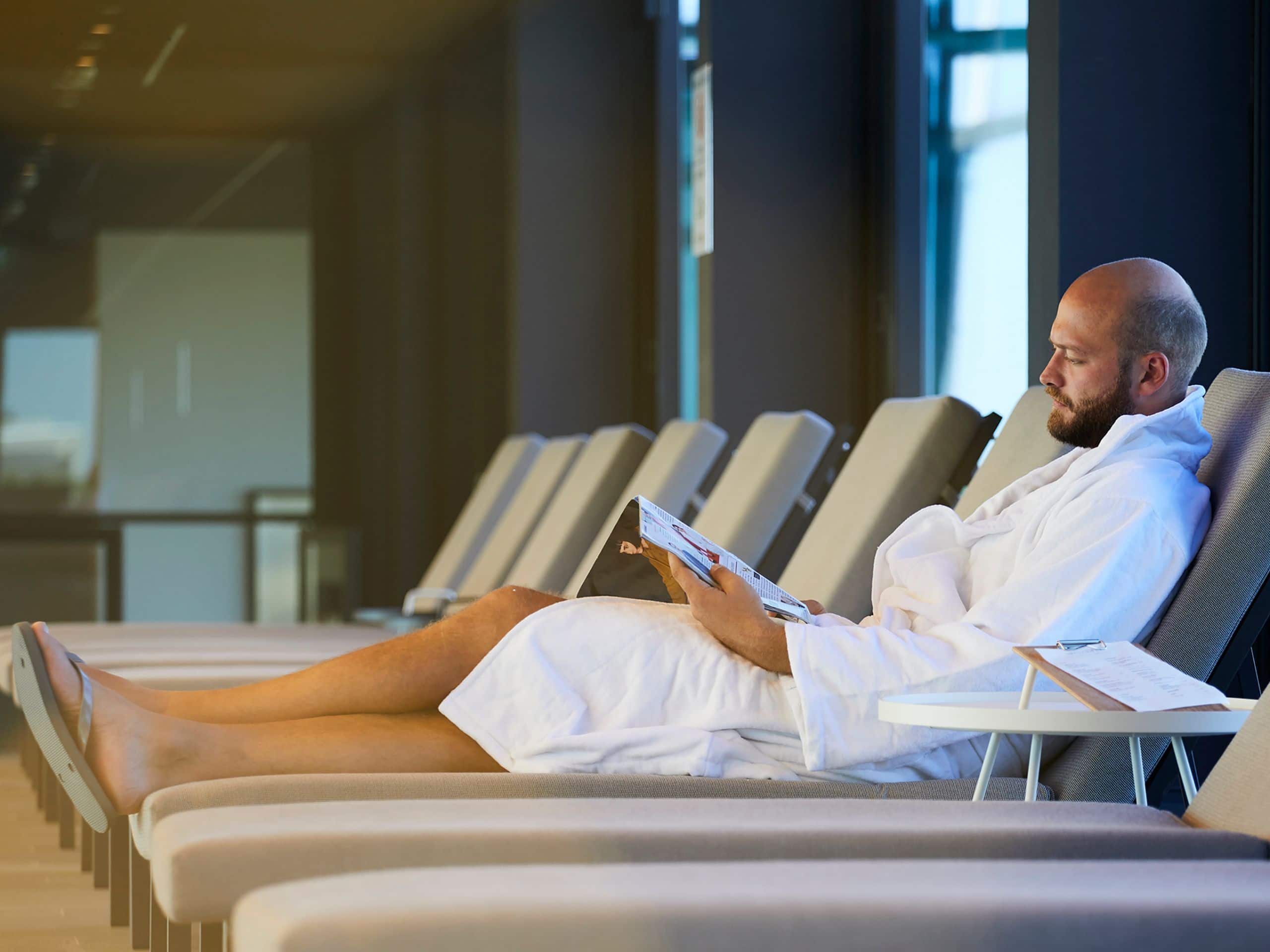 Andaz Munich Schwabinger Tor Spa Row Of Sunchairs Man Reading