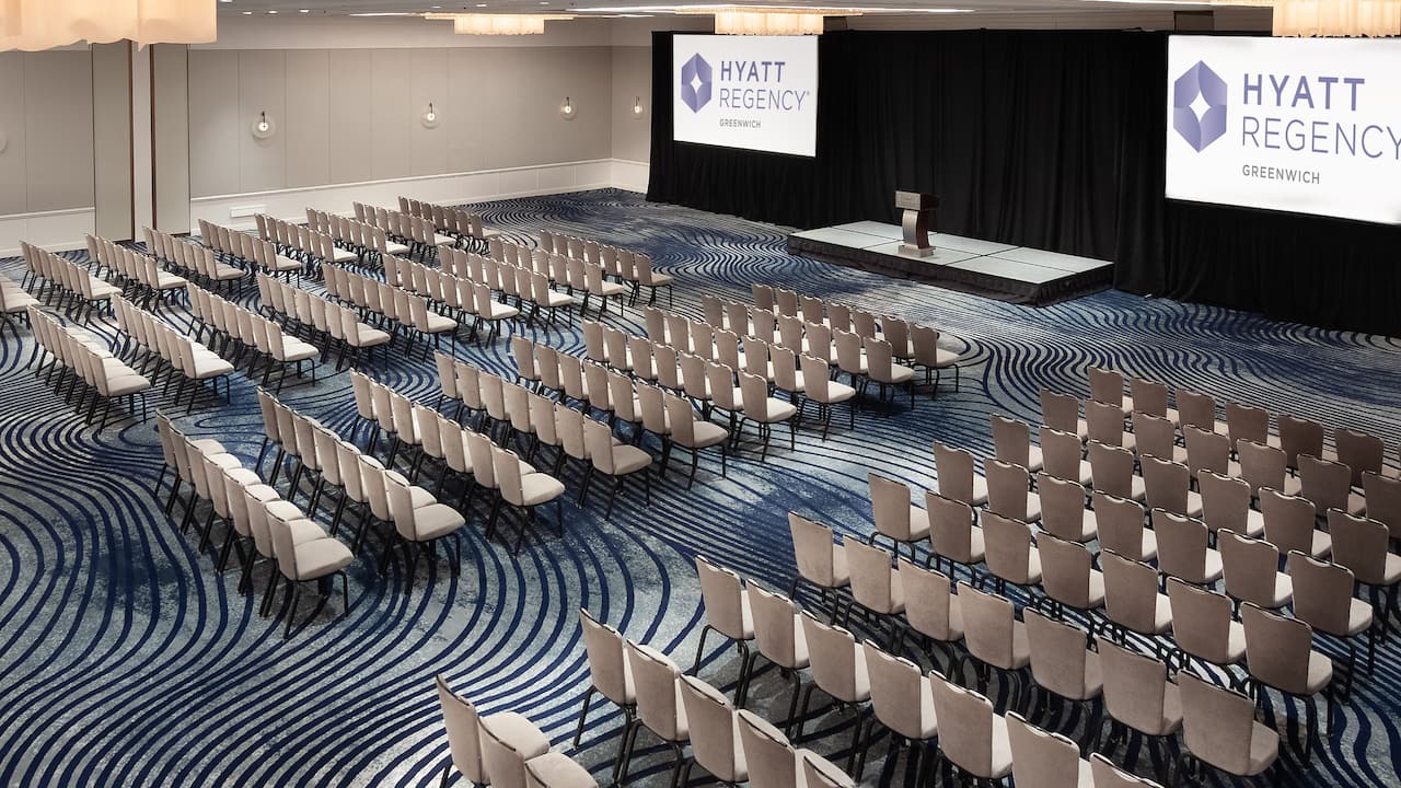 Regency Ballroom theater setup with stage and projector screens at Hyatt Regency Greenwich