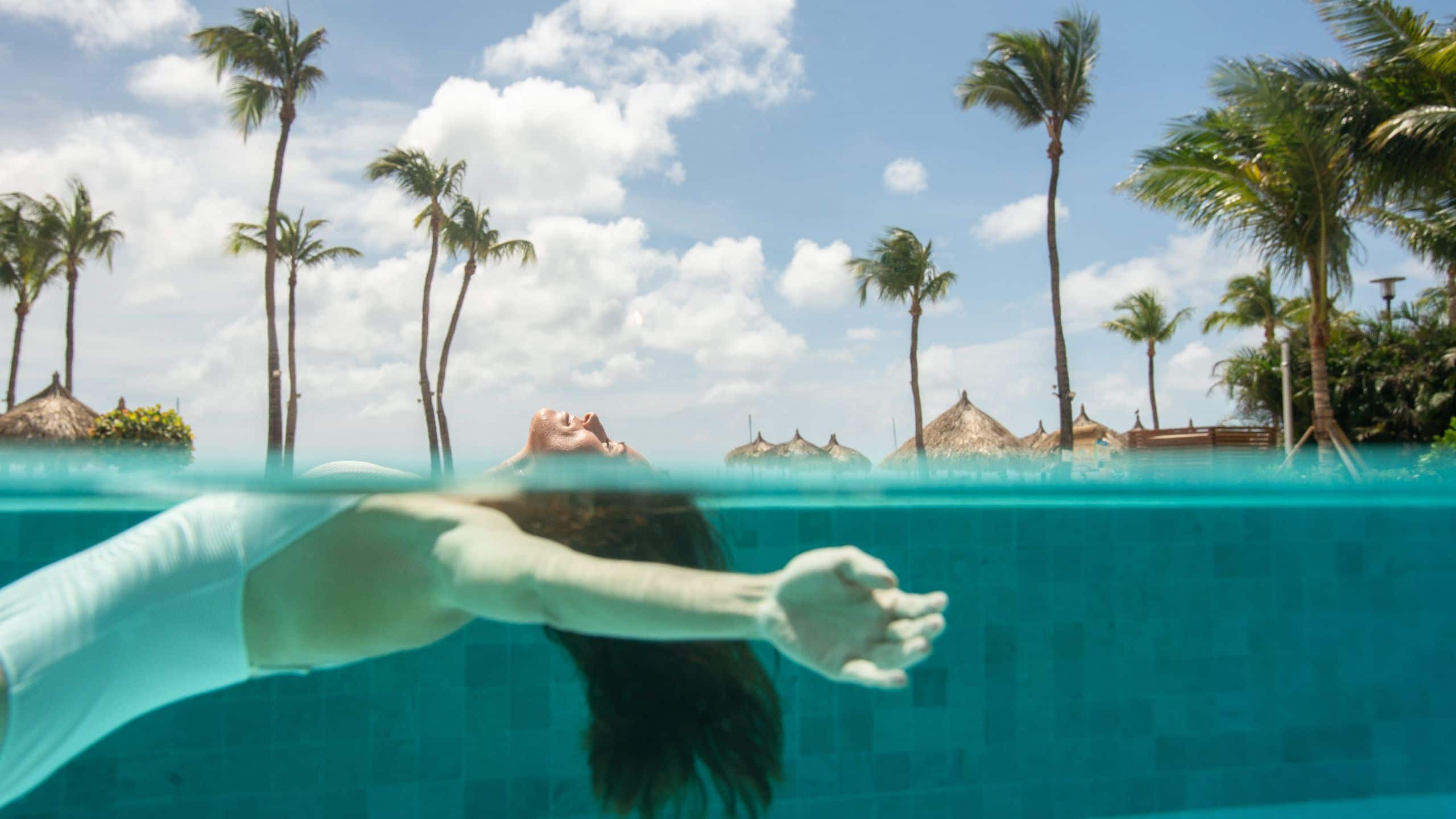 Woman enjoying the outdoor pool at Hyatt Regency Aruba Resort Spa and Casino