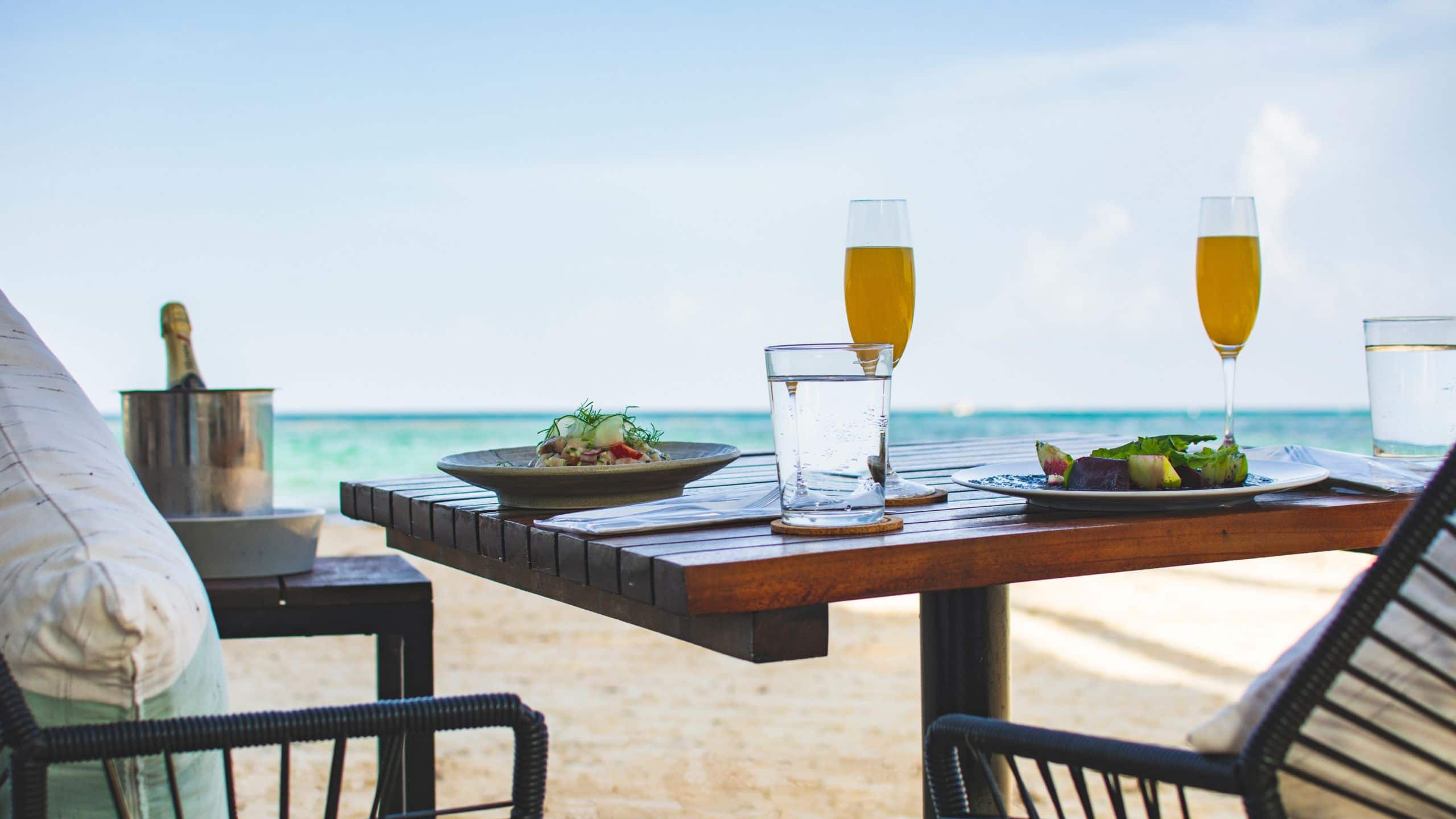 Beachside dining with salad and mimosa on Playa Del Carmen Beach
