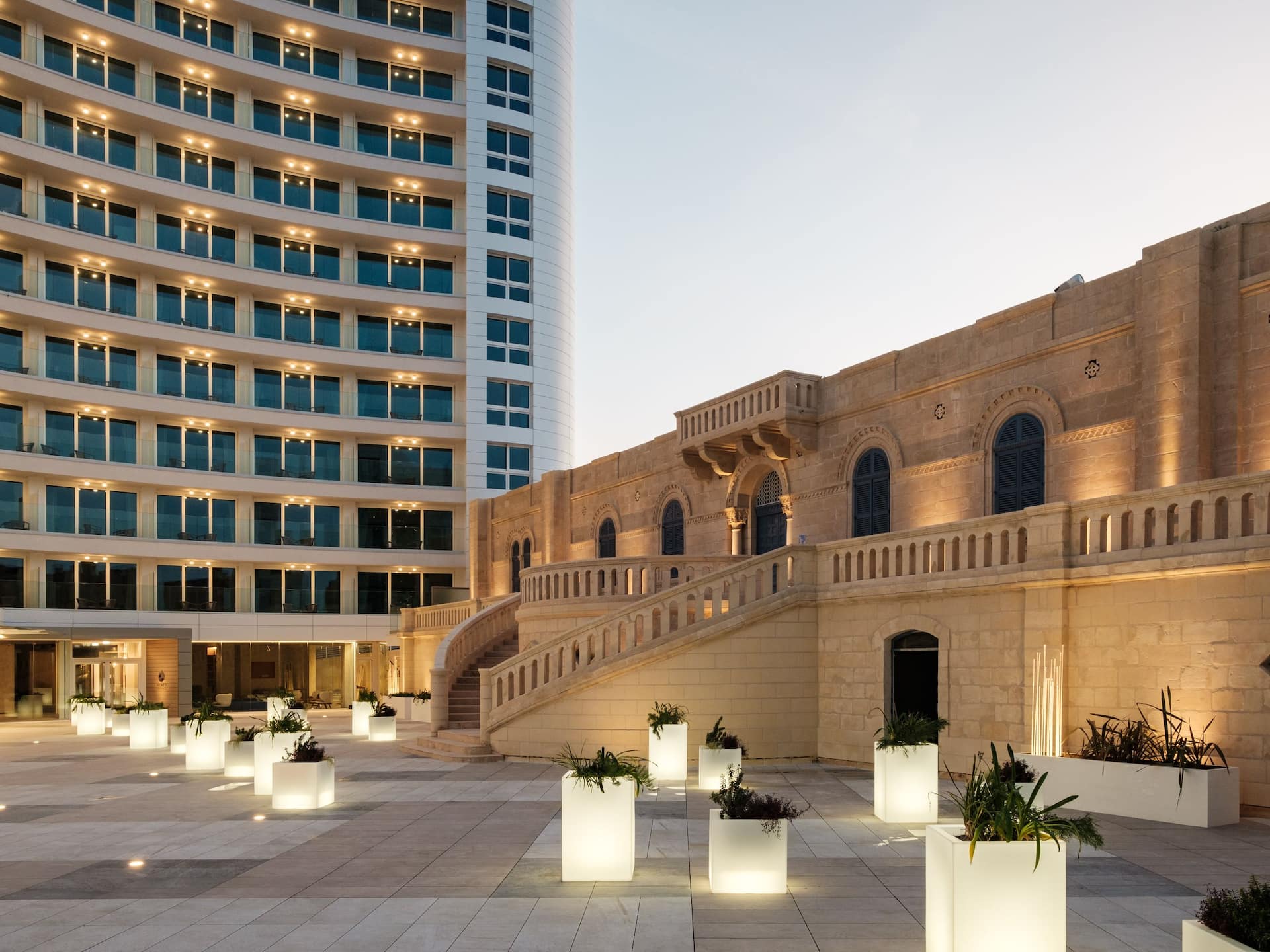 The Pjazza showing the santa rita chapel and front of the hotel with light up plant pots situated on the pjazza