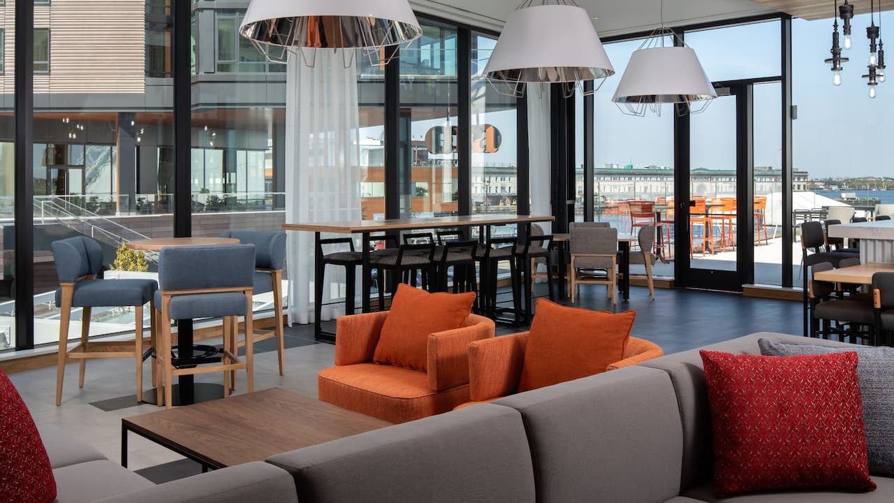 Hyatt Place Boston / Seaport District Café Seating with Harbor Water View of Seaport District