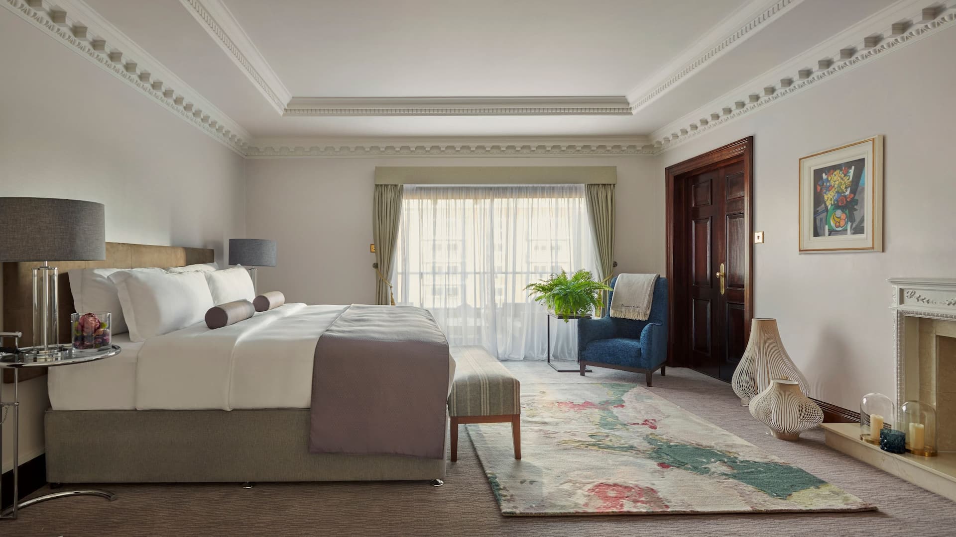 Master bedroom of the Churchill Residential Suite with plenty of natural light, generous space and elegant furnishings.