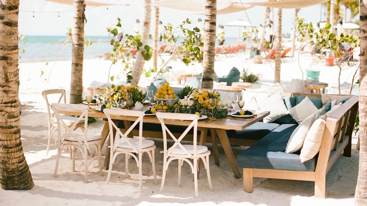 Beautifully decorated beachside dining table setup for a wedding at Riviera Maya