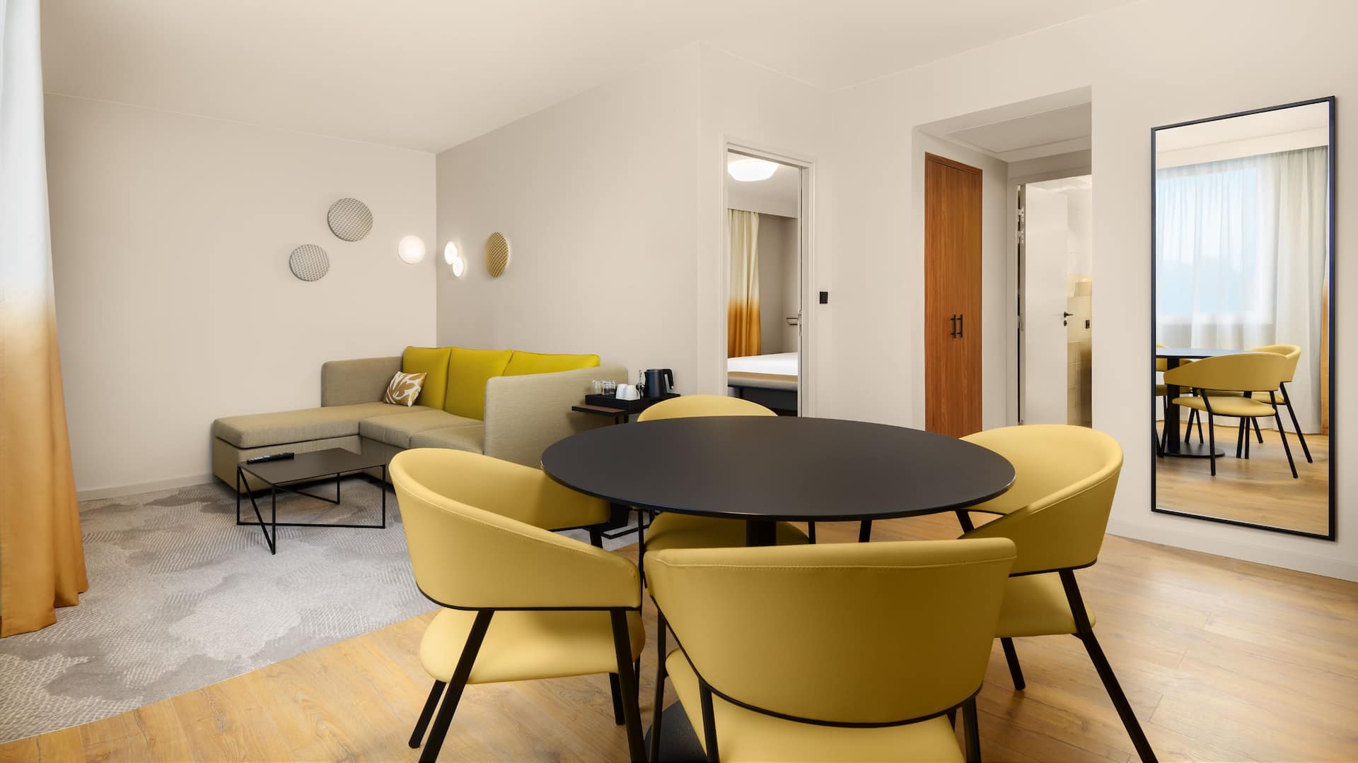 Hotel Suite with sofa and king bed at Hyatt Place Paris Charles de Gaulle Airport