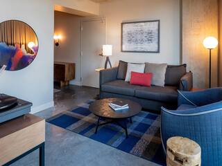 One Bedroom Suite living area with couch, chair, and coffee table