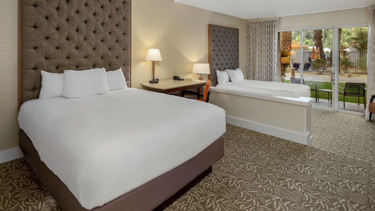 A spacious two queen bedroom with direct access to the outdoor pool at Hyatt Regency Indian Wells Resort & Spa