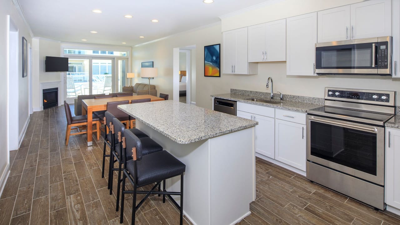 Condo with fully-equipped kitchen, separate living area and balcony 